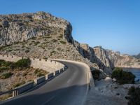 an empty highway winds off into the mountainside in california's cabo mountains