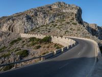 an empty highway winds off into the mountainside in california's cabo mountains