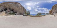 a 360 - view of a mountaintop road through a mirror that has an arch in the center and is on a bridge