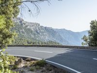 the empty roadway of this mountain road is very scenic and winding on the side of the road