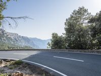 the empty roadway of this mountain road is very scenic and winding on the side of the road