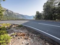 the empty roadway of this mountain road is very scenic and winding on the side of the road