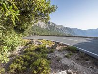 the empty roadway of this mountain road is very scenic and winding on the side of the road