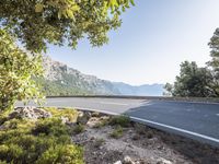 the empty roadway of this mountain road is very scenic and winding on the side of the road