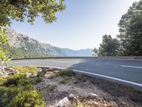 the empty roadway of this mountain road is very scenic and winding on the side of the road