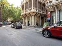 a street scene with a car parked along side the road and a building near by