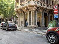 a street scene with a car parked along side the road and a building near by