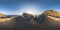 a very wide, curved highway with a cliff in the background as seen through an eye lens