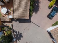 a street with an overhead shot of a car parked on it's side with the top off in the shot