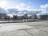 a man on a city waterfront with buildings behind him and one person walking away from the other