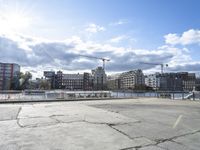 a man on a city waterfront with buildings behind him and one person walking away from the other