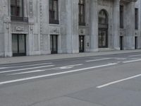 a man wearing a helmet and holding a red frisbee crossing the street in front of a building