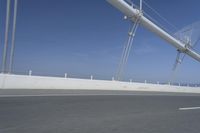 a man is riding his bicycle along the highway with a view of the sky in the background