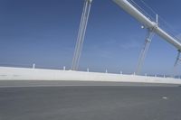 a man is riding his bicycle along the highway with a view of the sky in the background
