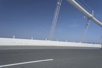 a man is riding his bicycle along the highway with a view of the sky in the background