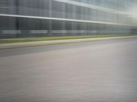 a man riding his bike through the city streets in motion on a blurry street