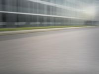 a man riding his bike through the city streets in motion on a blurry street