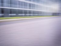 a man riding his bike through the city streets in motion on a blurry street