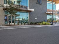 a man is riding his bike in front of the shopfront of an arubaa