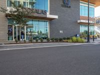 a man is riding his bike in front of the shopfront of an arubaa