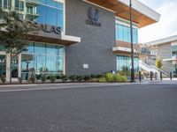 a man is riding his bike in front of the shopfront of an arubaa