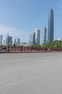 a man riding his bike on a street near buildings and trees in shanghai, china