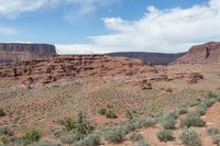 there is a man riding a horse through the wilderness in this picture, along with his back pack