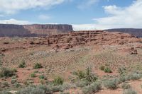 there is a man riding a horse through the wilderness in this picture, along with his back pack