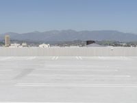 a man flying a kite while on his skateboard in the air outside an airport