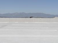 a man flying a kite while on his skateboard in the air outside an airport