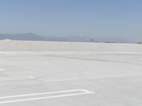 a man flying a kite while on his skateboard in the air outside an airport