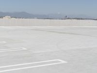 a man flying a kite while on his skateboard in the air outside an airport