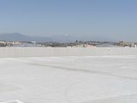 a man flying a kite while on his skateboard in the air outside an airport