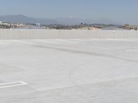 a man flying a kite while on his skateboard in the air outside an airport