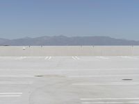 a man flying a kite while on his skateboard in the air outside an airport