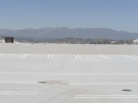 a man flying a kite while on his skateboard in the air outside an airport