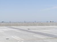 a man flying a kite while on his skateboard in the air outside an airport