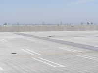 a man flying a kite while on his skateboard in the air outside an airport