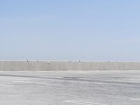 a man flying a kite while on his skateboard in the air outside an airport