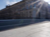 a man is riding a skateboard down a city street in front of a building