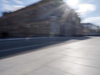 a man is riding a skateboard down a city street in front of a building