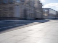 a man is riding a skateboard down a city street in front of a building