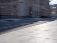 a man is riding a skateboard down a city street in front of a building