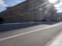 a man is riding a skateboard down a city street in front of a building