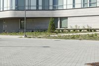 a man riding a skateboard in the street on a bike next to a building