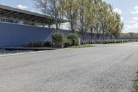 a man is riding his skate board on the sidewalk and doing a trick down the street