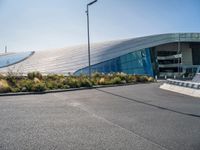 a man on a skateboard in front of an outdoor building that's on the pavement, as if it was the roof