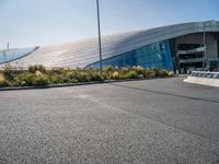 a man on a skateboard in front of an outdoor building that's on the pavement, as if it was the roof