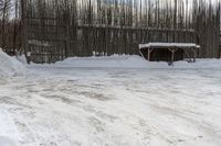 a man is jumping up a ramp with some skis on his feet near a barn