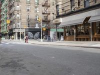 a man is walking on a sidewalk with a suitcase in one hand and the other in the other